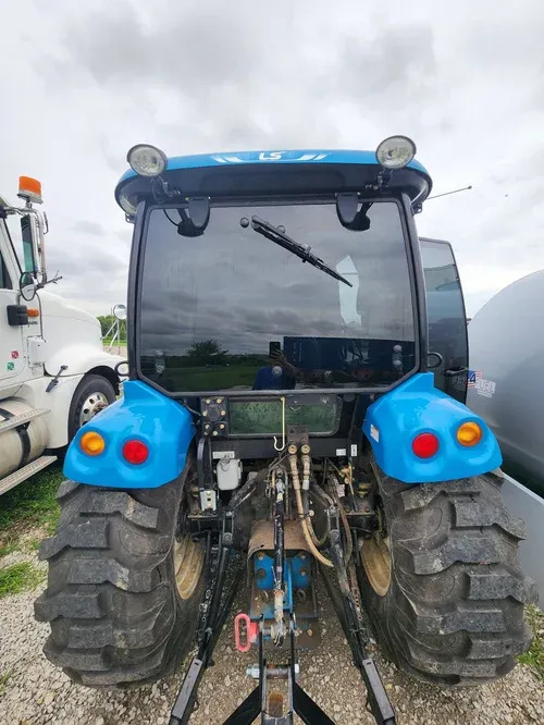 Rear view of a blue agricultural tractor with custom window tinting installed by Valion Tinting, demonstrating our ability to handle specialty and heavy equipment glass in Kansas City